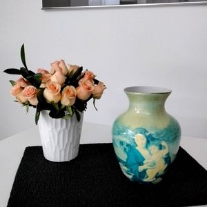 Vintage vase with Madonna and child pictured on two sides.